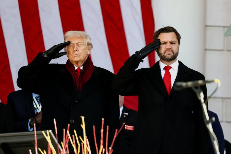 U.S. President Donald Trump and Vice President JD Vance salute during a Veterans Day ceremony at Arlington National Cemetery in Arlington, Virginia, U.S., November 11, 2025.