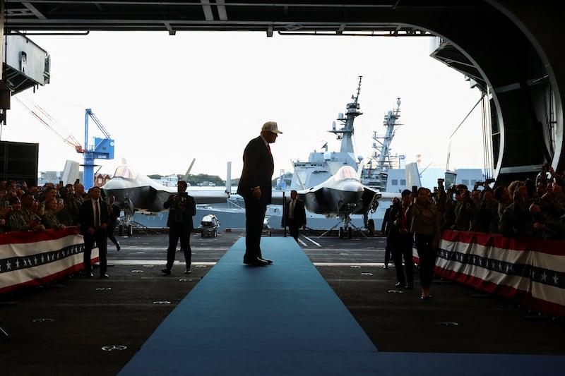 U.S. President Donald Trump looks on towards U.S. Navy sailors, aboard the aircraft carrier USS George Washington, during a visit to U.S. Navy's Yokosuka base in Yokosuka, Japan, October 28, 2025.