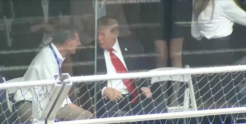 As Trump talks, Melania (white blouse) gets up to leave after noticing Harp (black skirt) hovering behind her.