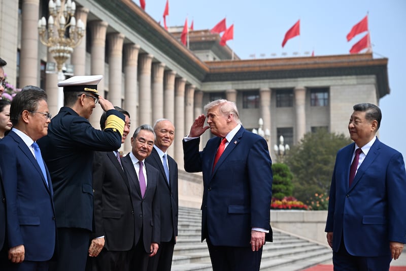 BEIJING, CHINA - MAY 14: U.S. President Donald Trump trailed by Chinese President Xi Jinping greets other officials at the Great Hall of the People on May 14, 2026 in Beijing, China. The trip by Trump is focused on trade, regional security, and strengthening bilateral ties between the world's two largest economies. (Photo by Kenny Holston-Pool/Getty Images)