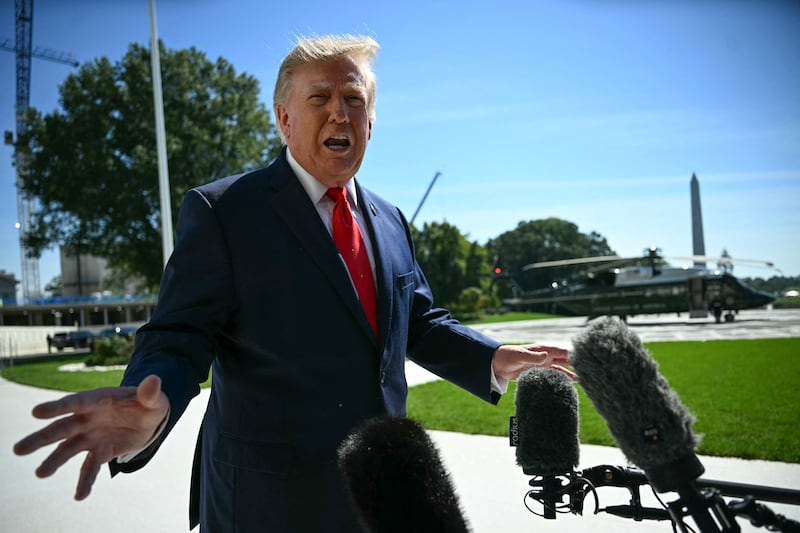 US President Donald Trump talks to members of the press before boarding Marine One from the South Lawn of the White House in Washington, DC, on October 1, 2026.