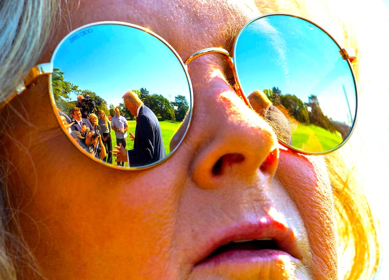 US President Donald Trump is reflected in the glasses of White House Chief of Staff Susie Wiles