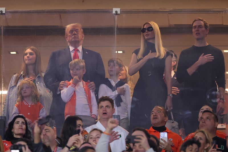 MIAMI GARDENS, FLORIDA - JANUARY 19: U.S. President Donald Trump stands for the National Anthem with his family prior to a game between the Miami Hurricanes and the Indiana Hoosiers in the 2026 College Football Playoff National Championship at Hard Rock Stadium on January 19, 2026 in Miami Gardens, Florida.  (Photo by Alex Slitz/Getty Images)