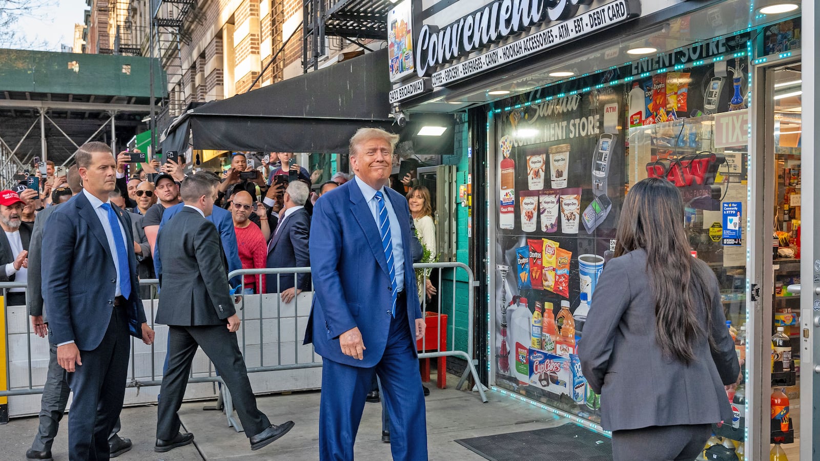A photo of Donald Trump smiling as he walks into a bodega in Manhattan.