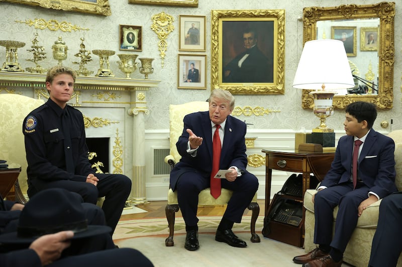 WASHINGTON, DC - AUGUST 17: U.S. President Donald Trump meets with 16-year-old California State Parks lifeguard Ryder Williams (L) in the Oval Office at the White House on August 17, 2026 in Washington, DC. Williams rescued 10-year-old Nathaniel Rai (R) in rough surf at Seabright Beach in Santa Cruz, California in July. (Photo by Alex Wong/Getty Images)