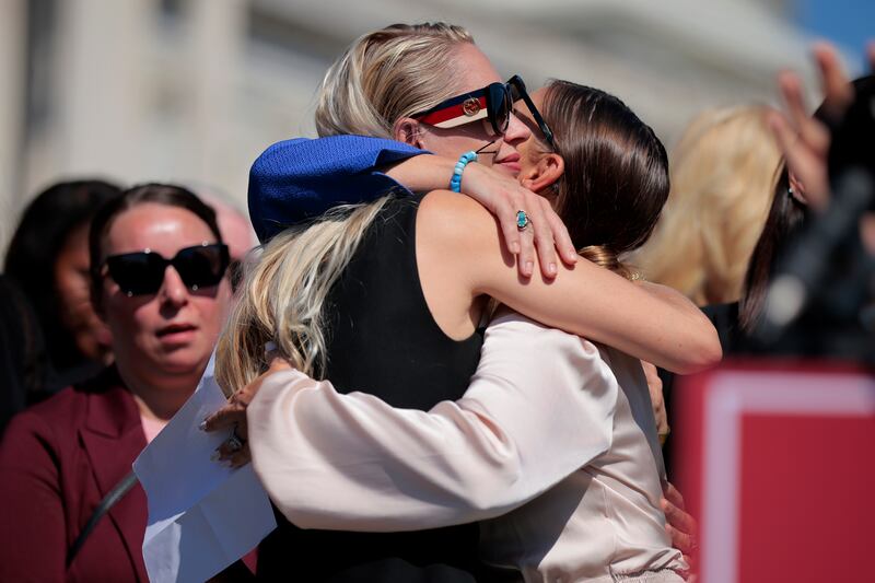 Survivor Chauntae Davies (R) embraces survivor Anouska De Georgiou during a news conference with alleged victims of disgraced financier and sex trafficker Jeffrey Epstein outside the U.S. Capitol.