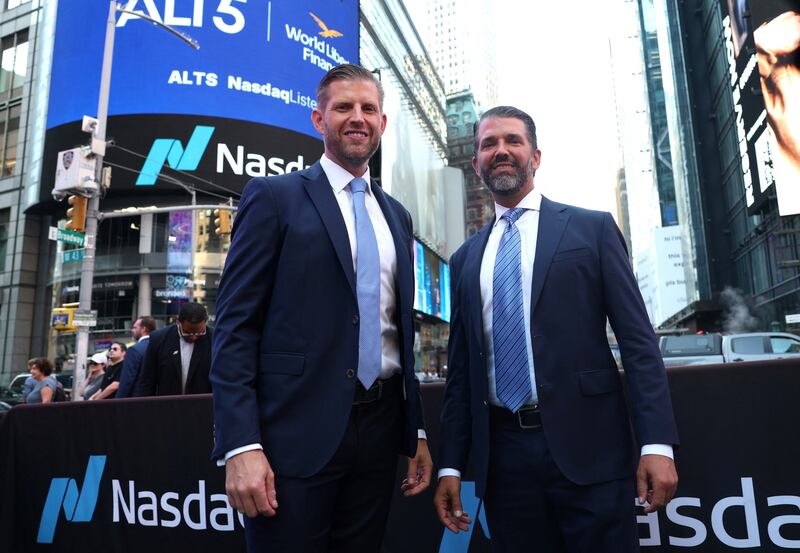 Eric Trump (L), newly appointed ALT5 Board Director, and ALT5 Board Observer Donald Trump Jr. pose outside Nasdaq in Times Square in New York on August 13, 2025 as World Liberty Financial and ALT5 Sigma ring the Nasdaq Stock Market opening Bell. (Photo by TIMOTHY A. CLARY / AFP) (Photo by TIMOTHY A. CLARY/AFP via Getty Images)