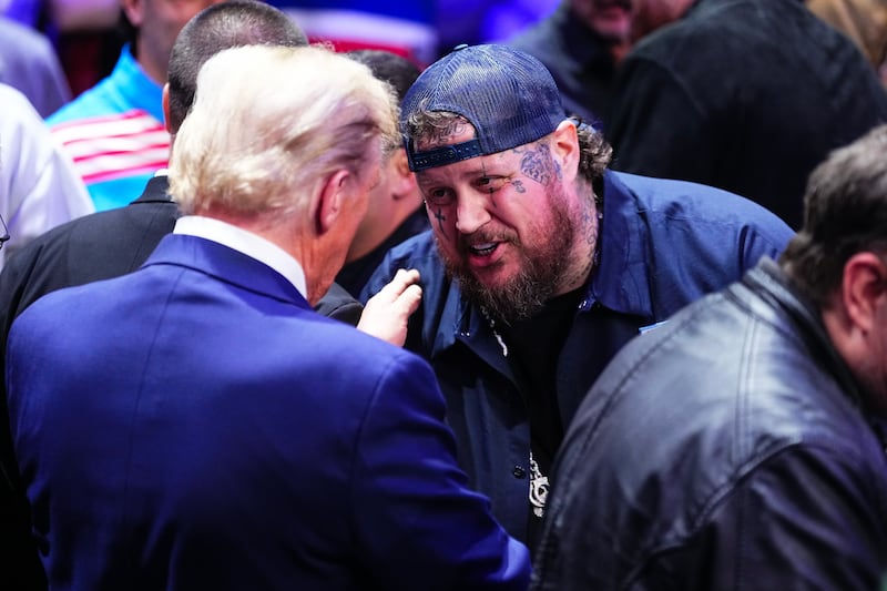 NEW YORK, NEW YORK - NOVEMBER 16: Musical Artist Jelly Roll shakes hands with President-elect Donald Trump during the UFC 309 event at Madison Square Garden on November 16, 2024 in New York City. (Photo by Jeff Bottari/Zuffa LLC)