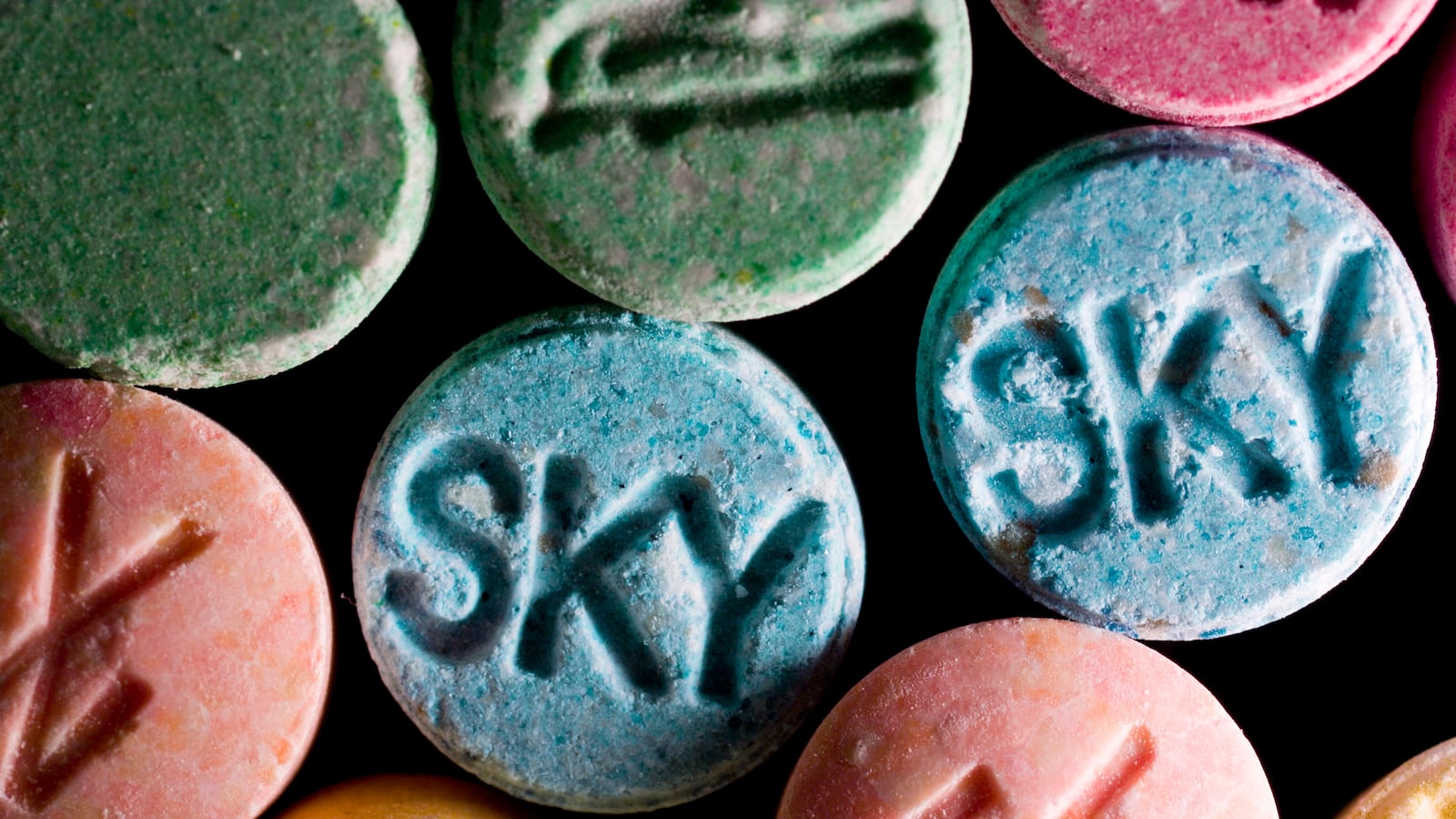 Ecstasy pills are laid out next to each other