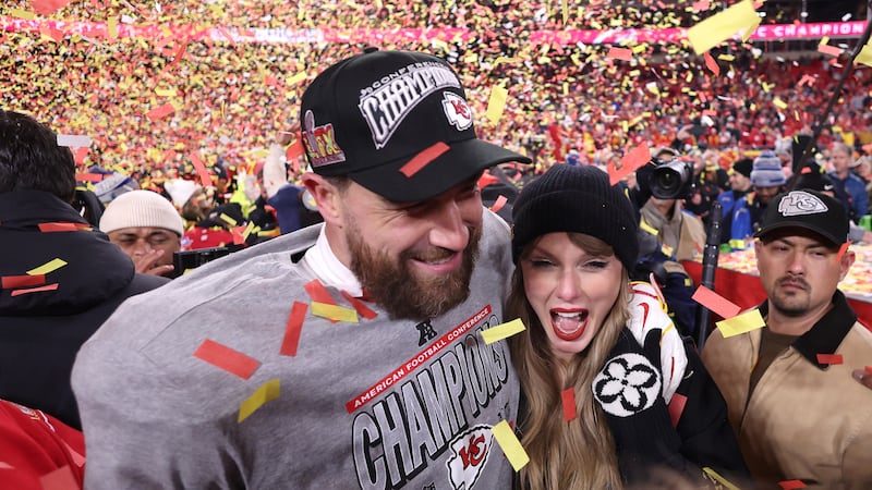 KANSAS CITY, MISSOURI - JANUARY 26: Taylor Swift celebrates with Travis Kelce #87 of the Kansas City Chiefs after defeating the Buffalo Bills 32-29 in the AFC Championship Game at GEHA Field at Arrowhead Stadium on January 26, 2025 in Kansas City, Missouri.