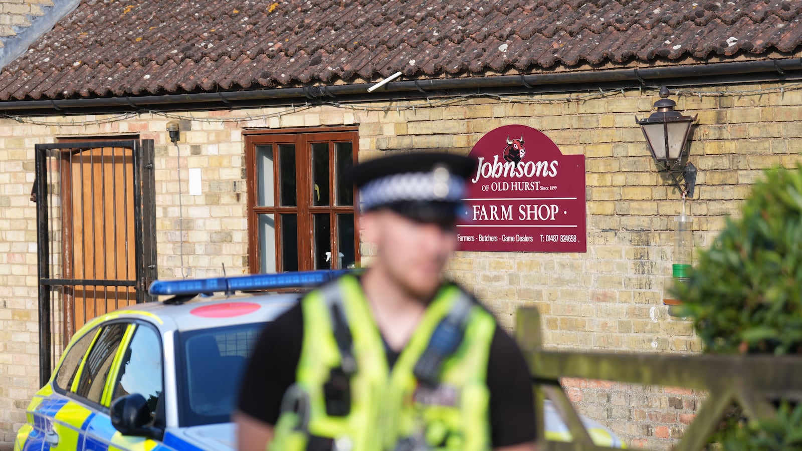 Policeman in front of Johnson's of Old Hurst