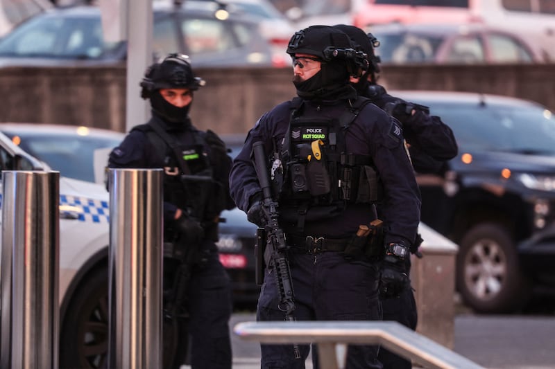 Armed police work at the scene after a shooting incident at Bondi Beach in Sydney on December 14, 2025.