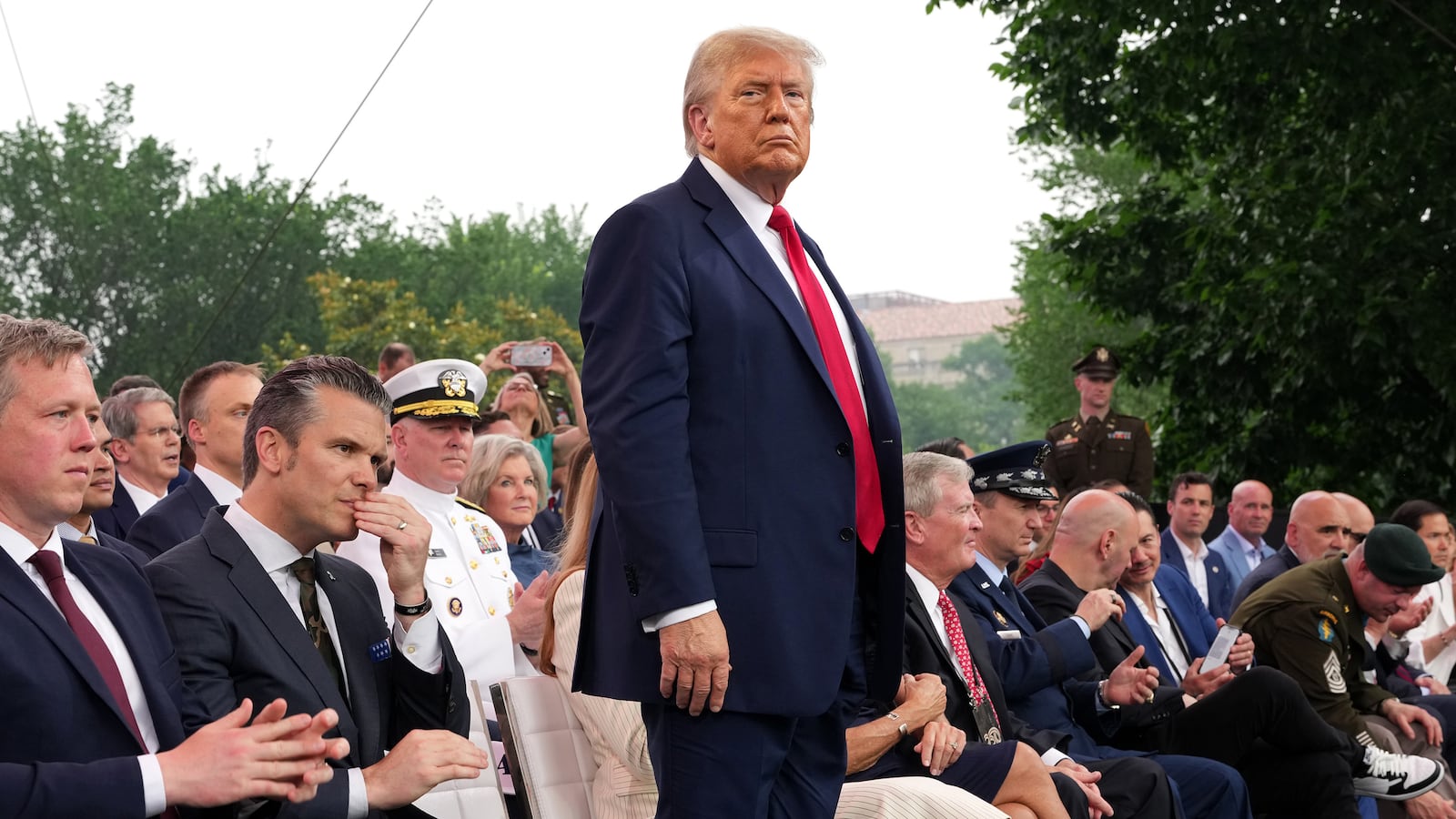 President Donald Trump stands during the celebration of the Army's 250th birthday on the National Mall on June 14, 2025 in Washington, DC. The U.S. Army is marking its 250th anniversary with a military parade along Constitution Avenue that includes roughly 6,600 troops, 150 vehicles, and over 50 aircraft. The parade, which coincides with President Donald Trump's 79th birthday, is designed to tell the history of the Army.