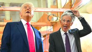 President Donald Trump speaks with Federal Reserve chair Jerome Powell (R) as he visits the Federal Reserve in Washington, DC, on July 24, 2025.