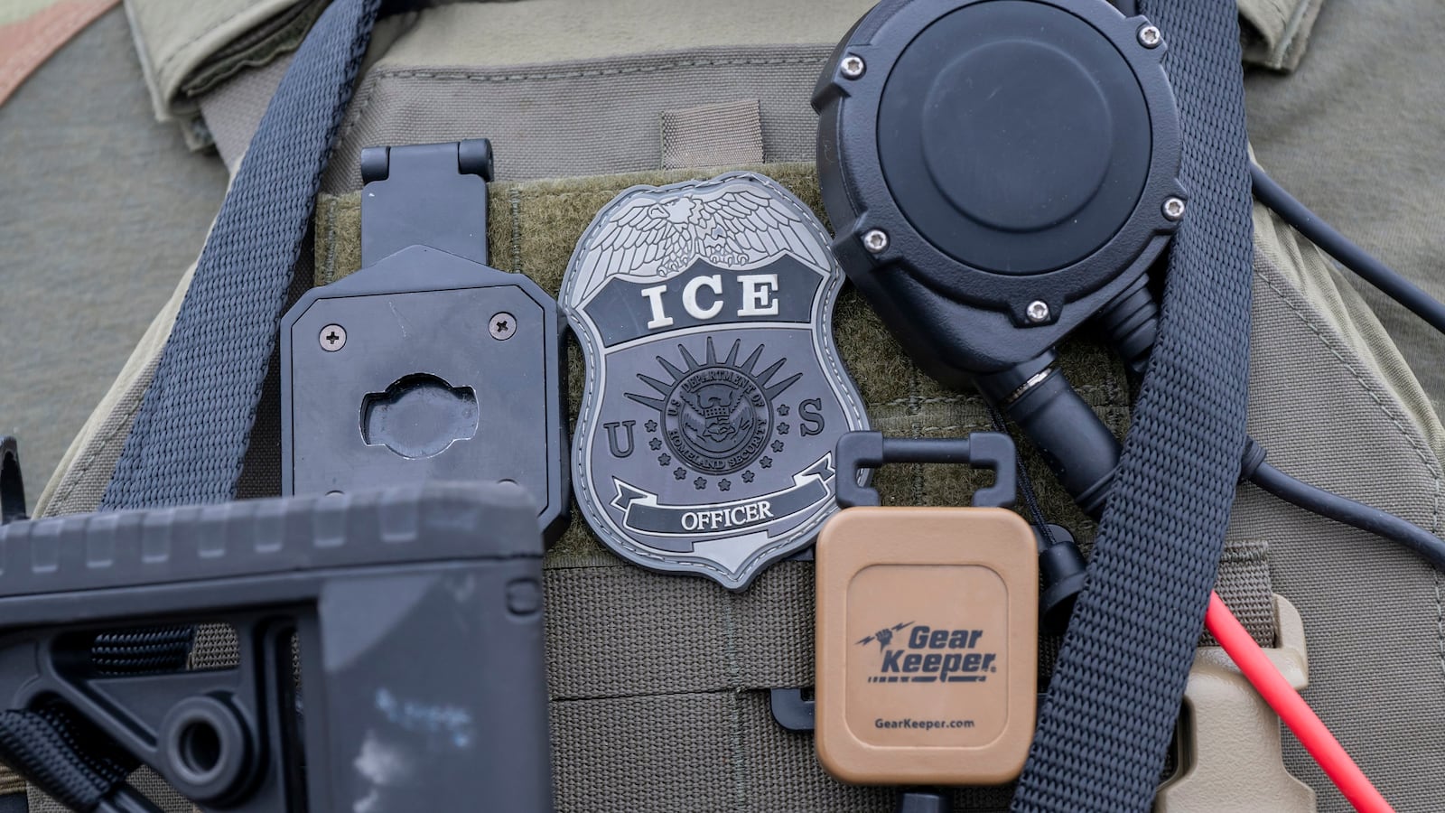 Closeup of ice officers badge and gear.