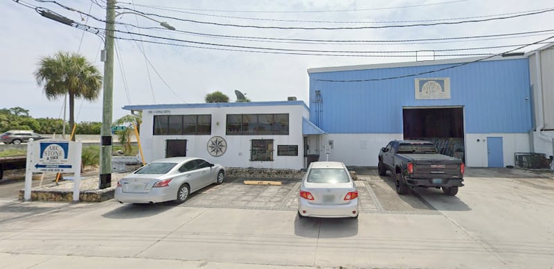 A warehouse with cars outside