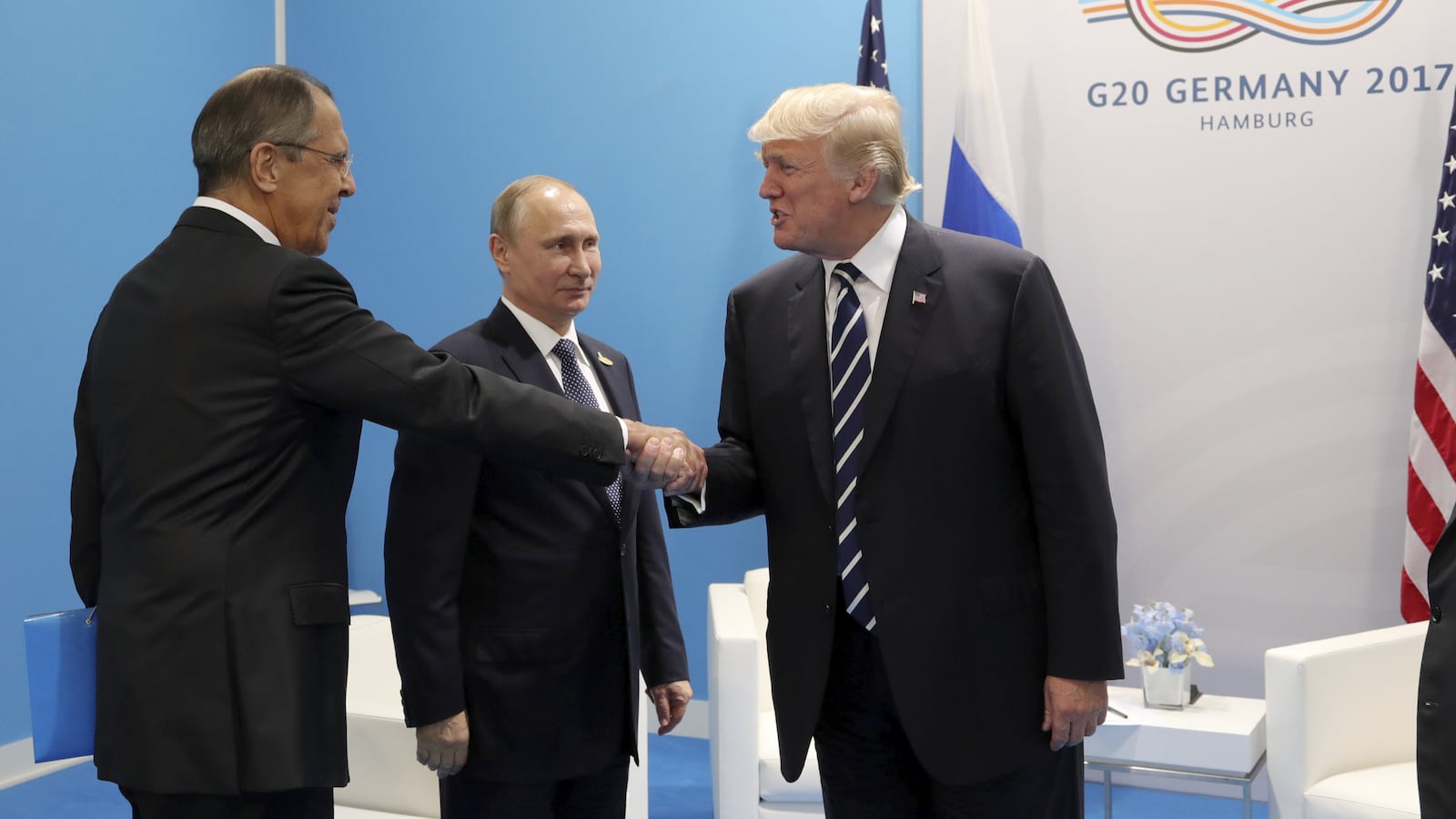 Former President Donald Trump shakes hands with Russian Foreign Minister Sergei Lavrov and Russian President Vladimir Putin