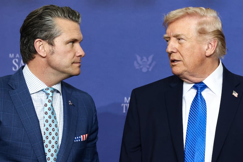 U.S. President Donald Trump speaks with Defense Secretary Pete Hegseth, as they attend a roundtable on public safety at Memphis Air National Guard Base in Memphis, Tennessee, U.S., March 23, 2026. REUTERS/Kevin Lamarque