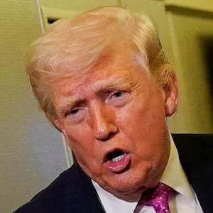 U.S. President Donald Trump talks to members of the media aboard Air Force One en route to Joint Base Andrews, Maryland, U.S., March 29, 2026.