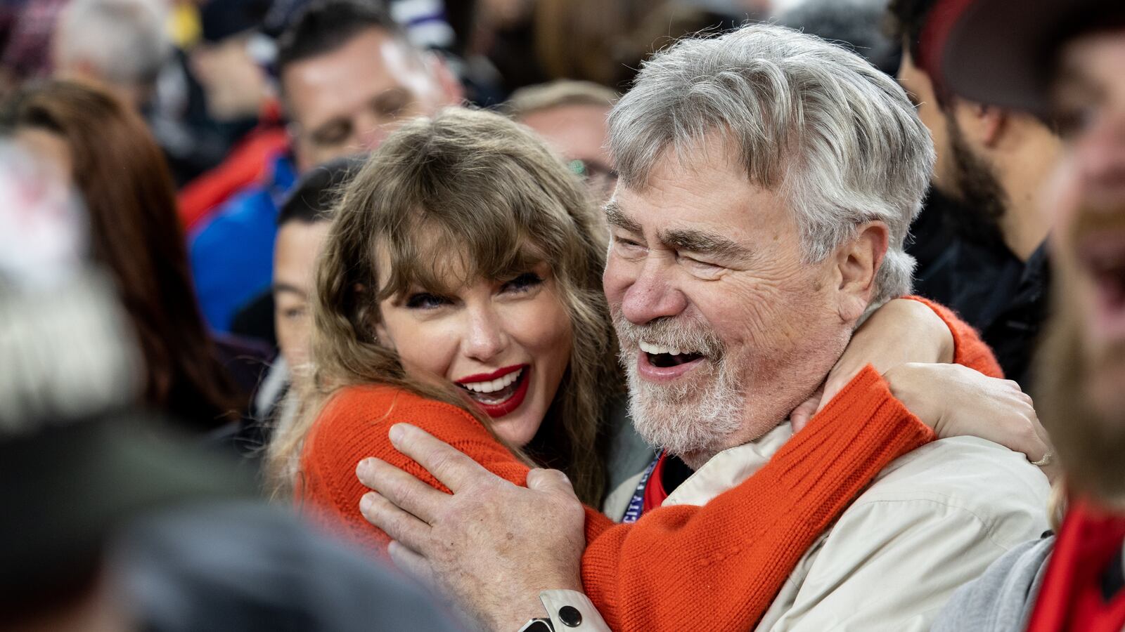 Taylor Swift and Ed Kelce on a football field.