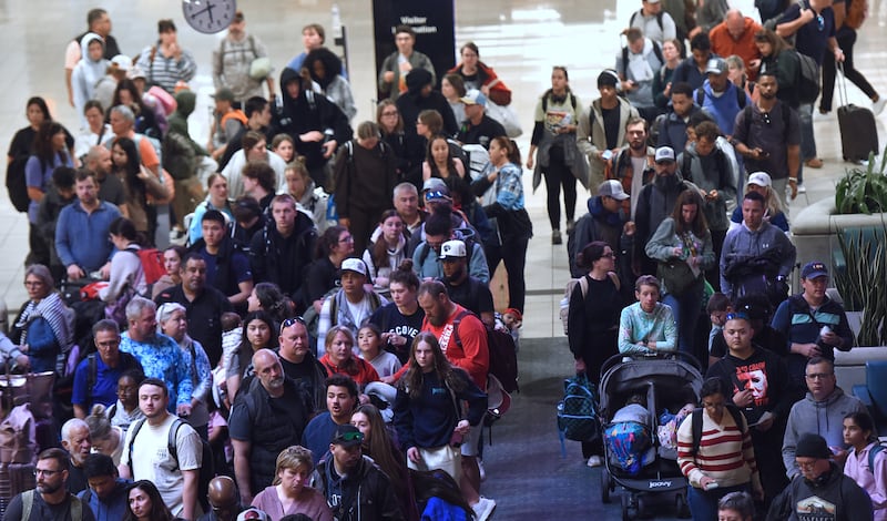 Travelers wait in a TSA screening line at Orlando International Airport on March 22, 2026 in Orlando, Florida.