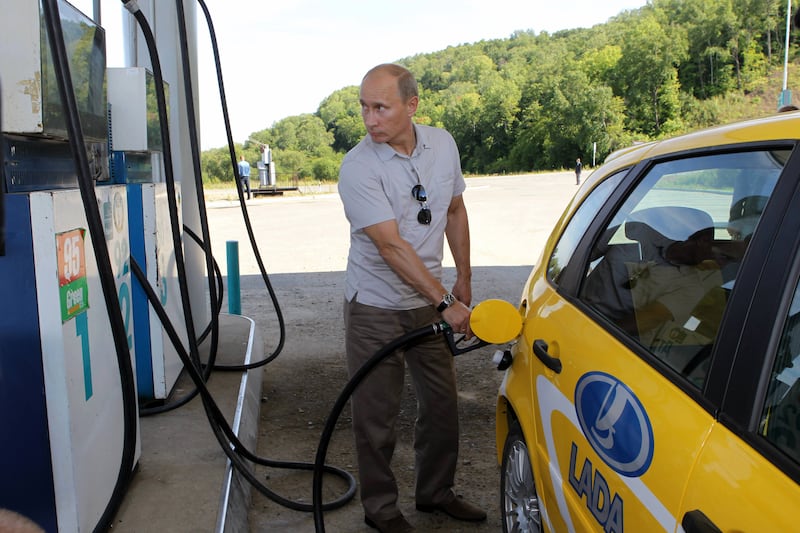 Russia's Prime Minister Vladimir Putin refuels a Russian-made Lada Kalina car as he stops at the petrol station in the Khabarovsk region on August 27, 2010. AFP PHOTO/ RIA-NOVOSTI/ ALEXEY DRUZHININ (Photo credit should read ALEXEY DRUZHININ/AFP via Getty Images)