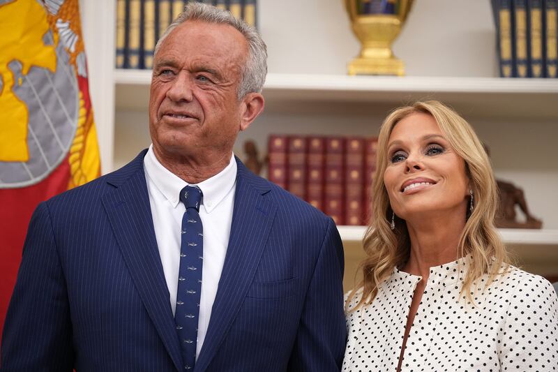 Robert F. Kennedy Jr. and his wife Cheryl Hines listen as U.S. President Donald Trump speaks before Kennedy is sworn in as Secretary of Health and Human Services in the Oval Office at the White House on February 13, 2025 in Washington, DC. Kennedy, who faced criticism for his past comments on vaccine, was confirmed by the Senate 52 to 48. Former Senate Republican Leader Mitch McConnell (R-KY) was the only Republican to vote against him.