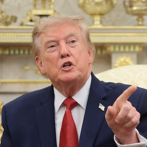 U.S. President Donald Trump speaks as he sits next to Nathaniel Rai, a child saved by 16-year-old lifeguard Ryder Williams off the coast of Santa Cruz, California, last month, while hosting him and Williams in the Oval Office, at the White House in Washington, D.C., U.S., August 17, 2026.