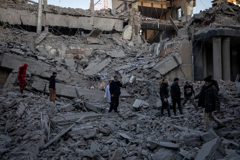 People stand in rubble at the site of an Israel and U.S. strike on a police station in Tehran, Iran, March 3, 2026. Majid Khahi/ISNA/WANA (West Asia News Agency) via REUTERS ATTENTION EDITORS - THIS PICTURE WAS PROVIDED BY A THIRD PARTY