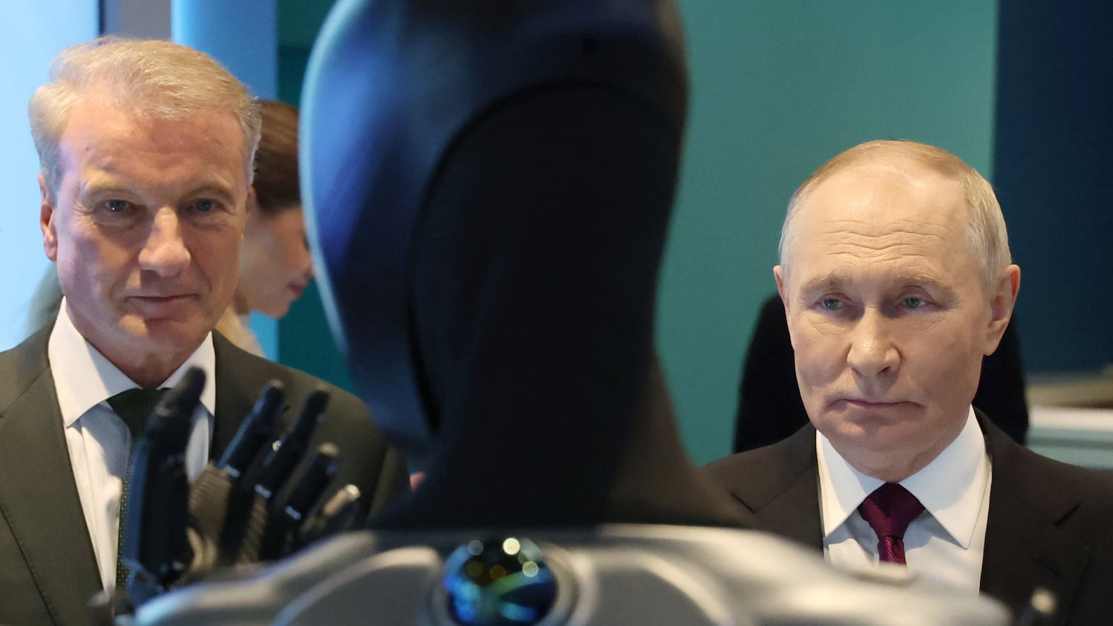 In this pool photograph distributed by the Russian state agency Sputnik, Russia's President Vladimir Putin, accompanied by Sberbank's CEO German Gref, visits an exhibition of the AI Journey international AI (Artificial intelligence) conference in Moscow on November 19, 2025. Russia's anthropomorphic AI-equipped robot developed by technology company Sber was presented to the Russian leader. (Photo by Vyacheslav PROKOFYEV / POOL / AFP) (Photo by VYACHESLAV PROKOFYEV/POOL/AFP via Getty Images)