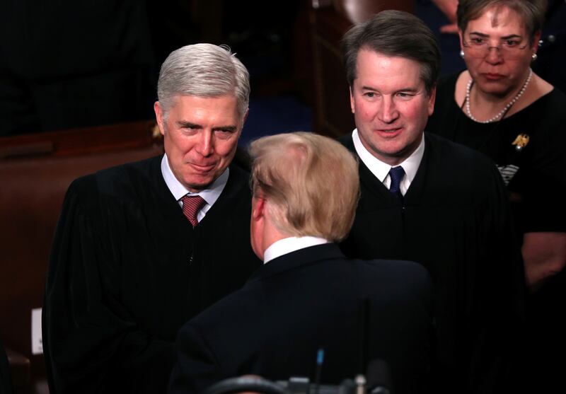 U.S. President Donald Trump talks with U.S. Supreme Court Justice Neil Gorsuch (L) and Associate Justice Brett Kavanaugh as he arrives to deliver his second State of the Union address to a joint session of the U.S. Congress in the House Chamber of the U.S. Capitol on Capitol Hill in Washington, U.S. February 5, 2019.