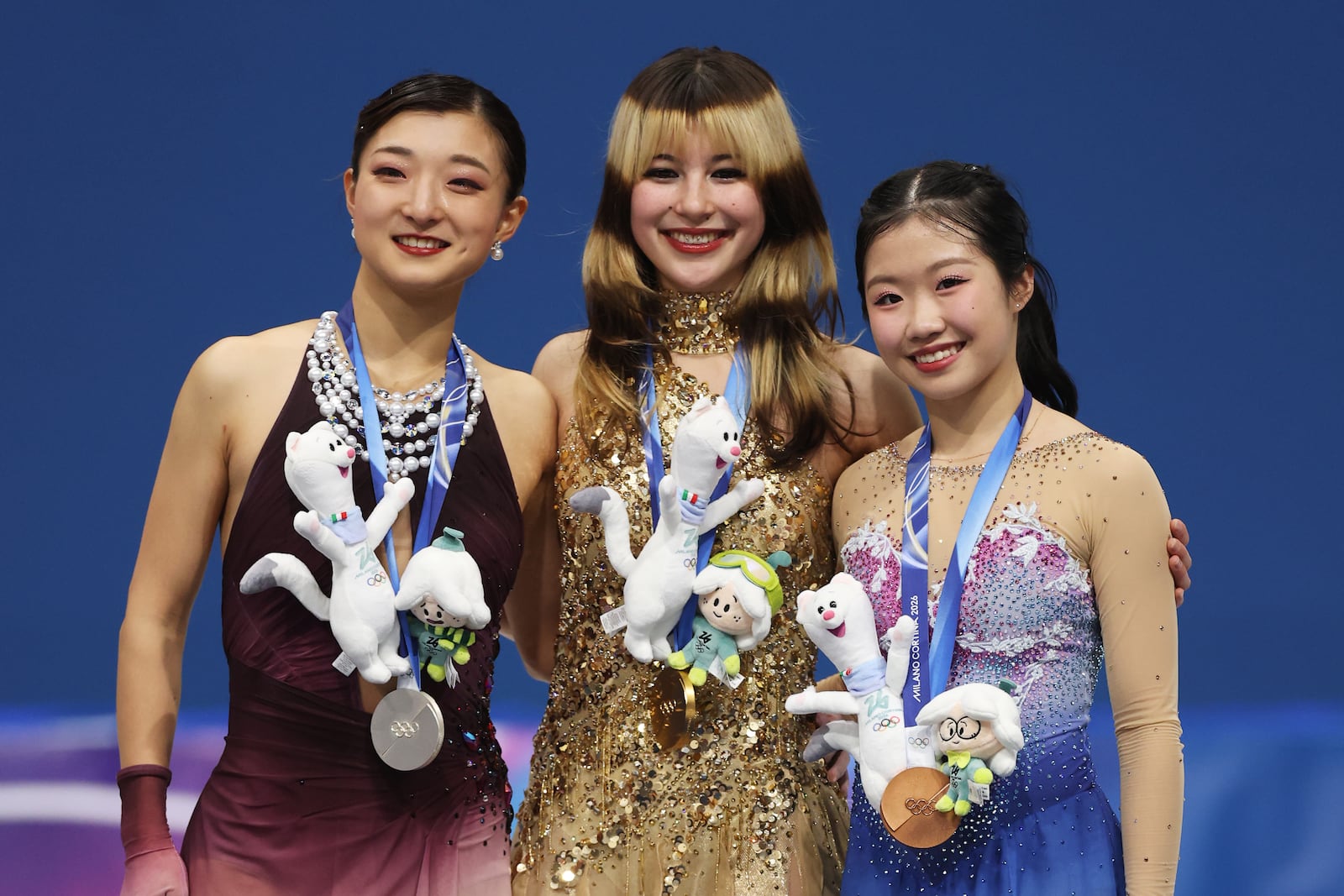 Gold medalist Alysa Liu of Team United States, silver medalist Kaori Sakamoto of Team Japan, and bronze medalist Ami Nakai of Team Japan pose for a photo on the podium during the medal ceremony for the Women's Single Skating on day 13 of the Milano Cortina 2026 Winter Olympic Games at Milano Ice Skating Arena on February 19, 2026.