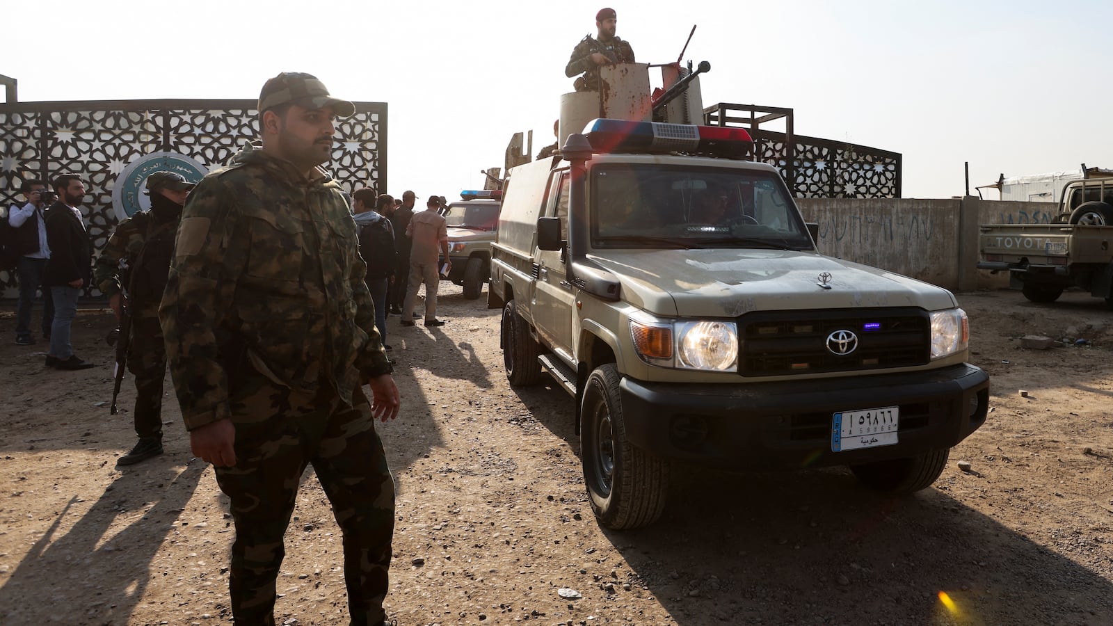 Members of an Iraqi Shi'ite armed group sit in a vehicle after an attack by a drone strike on an Iran-backed militia headquarters in Baghdad, Iraq January 4, 2024.