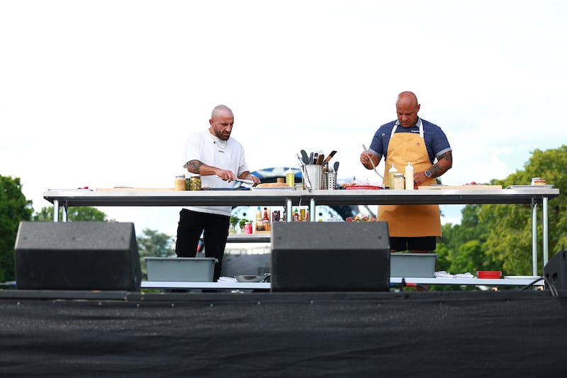 Chef Jonathan Dearden and UFC Fighter Alexander Volkanovski during a live "Cooking with Volk" show during the UFC Freedom 250 Fan Fest at The Ellipse on June 13, 2026 in Washington, D.C..