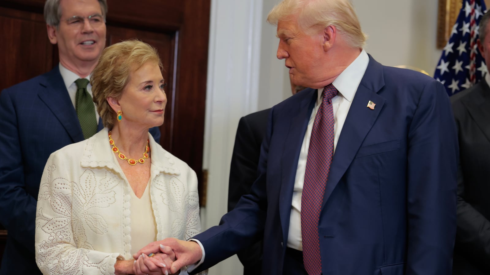 U.S. President Donald Trump speaks with Secretary of Education Linda McMahon.