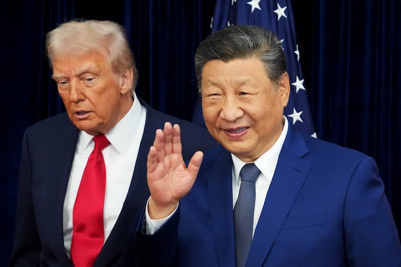 President Donald Trump and Chinese President Xi Jinping react after posing for photos ahead of a bilateral meeting at Gimhae Air Base on October 30, 2025 in Busan, South Korea.