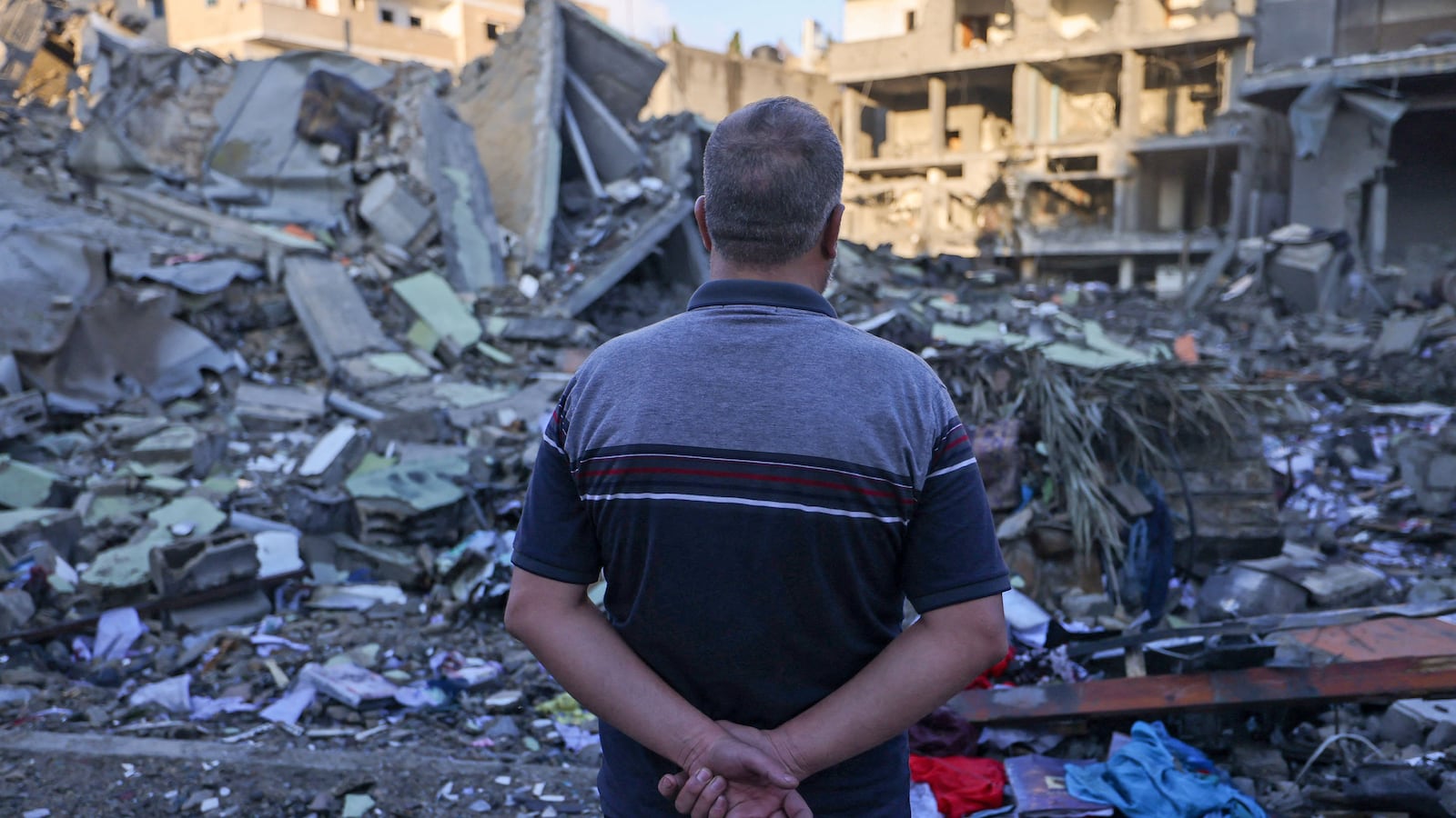 A Palestinian man looks on amid the rubble of buildings destroyed during Israeli airstrikes in the Rafah refugee camp in the southern of Gaza Strip.