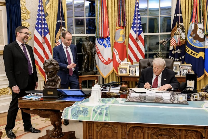 Donald Trump and Will Scharf are overlooking plans for the arch in the Oval Office.