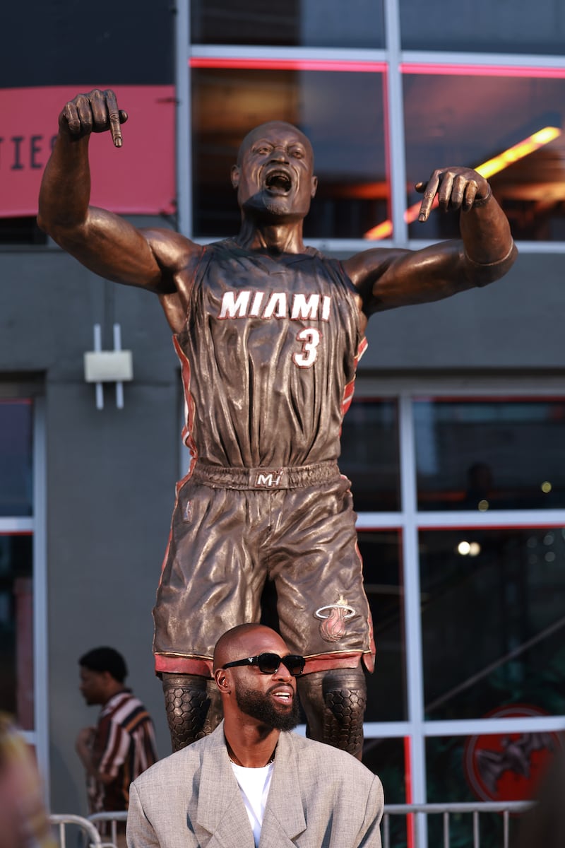 MIAMI, FLORIDA - OCTOBER 28: Dwyane Wade interacts with fans as they visit his statue that was unveiled on October 27th, prior to a game between the Miami Heat and the Detroit Pistons at Kaseya Center on October 28, 2024 in Miami, Florida. (Photo by Carmen Mandato/Getty Images)