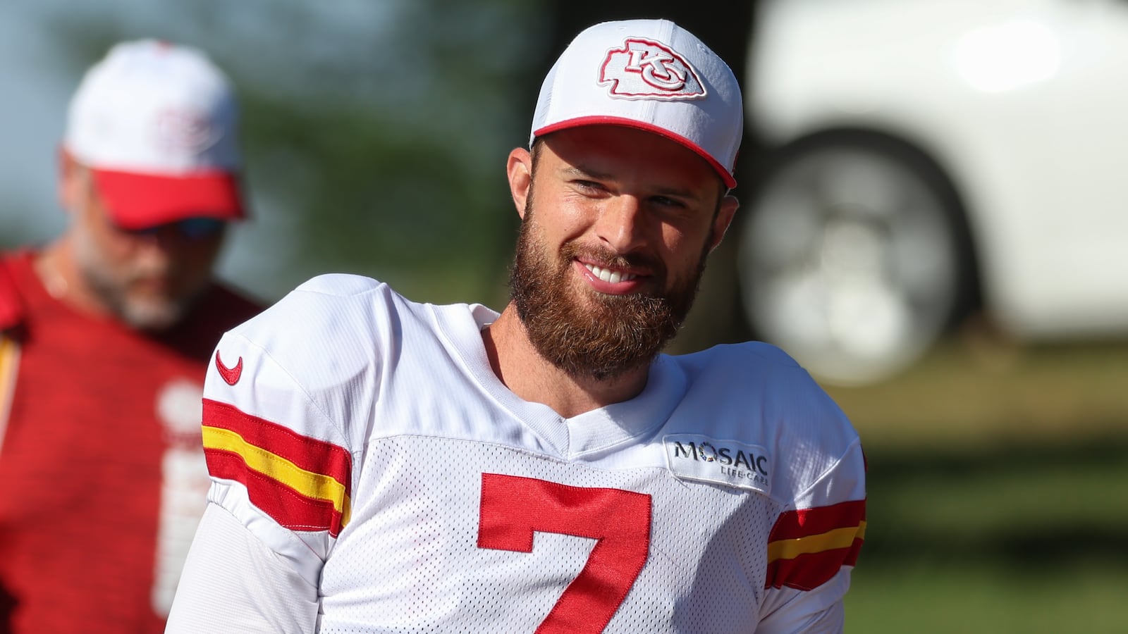 Harrison Butker smiling at a Kansas City Chiefs training camp.