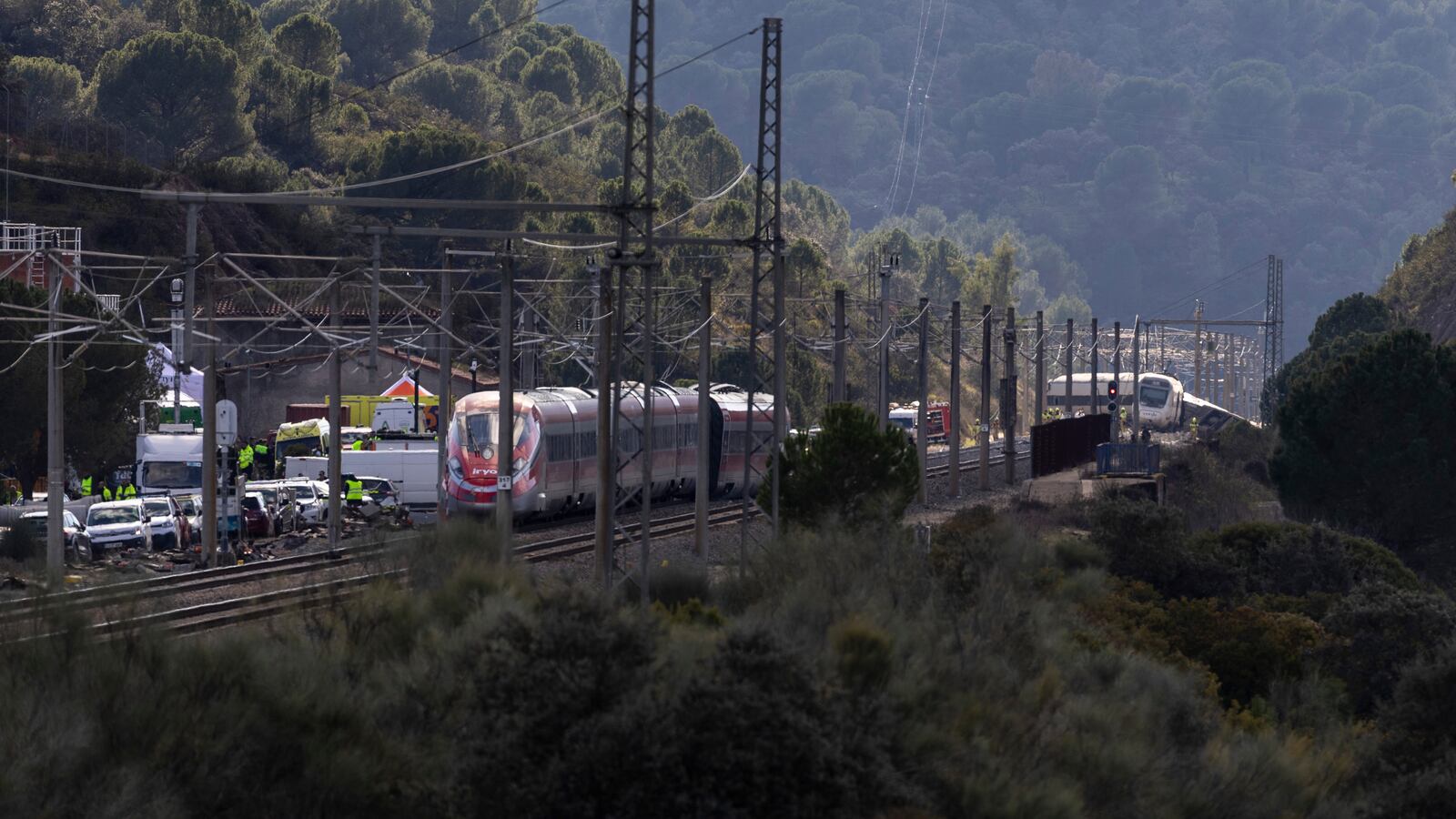 ADAMUZ, SPAIN - JANUARY 19: Emergency services work at the site of a train collision on January 19, 2026 after yesterday's train collision in Adamuz, Spain. Authorities say at least 39 were killed and more than 150 were injured when a train collided with a derailed train on the evening of Sunday, Jan. 18.