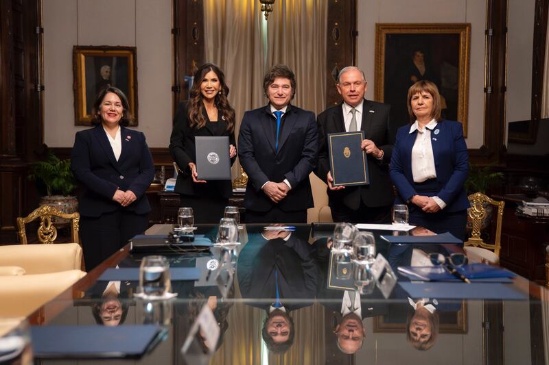 Kristi Noem (left center) poses with Argentina's president Javier Milei (center) and security minister Patricia Bullrich (right) after signing a visa waiver statement of intent.
