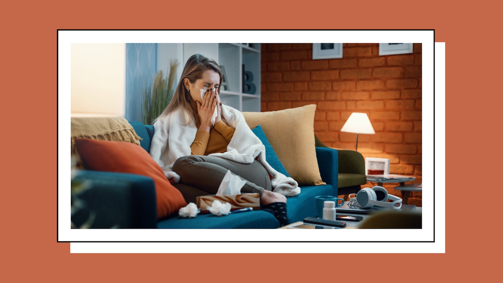 Woman with cold and flu blowing her nose