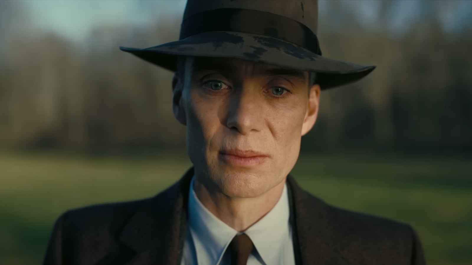 Cillian Murphy as Robert Oppenheimer stares at the camera, looking forlorn.