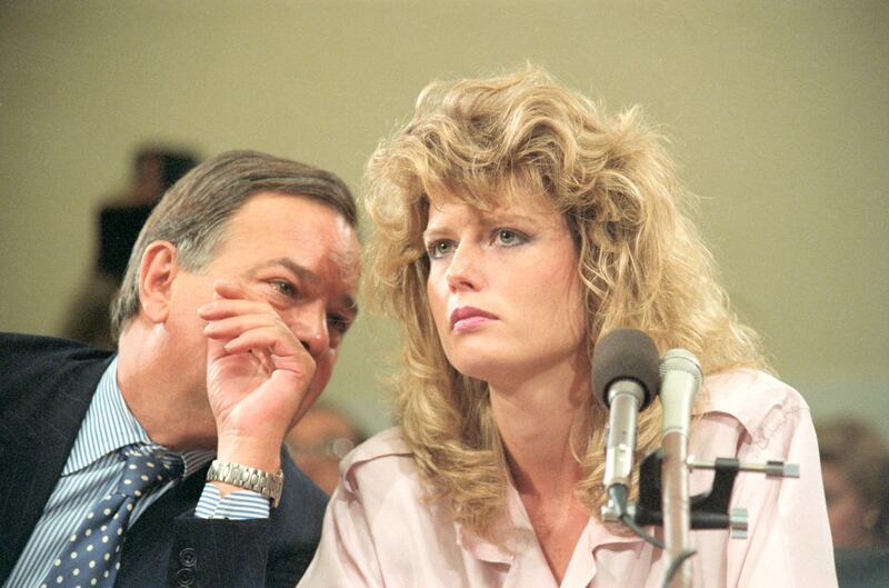 Fawn Hall, listens to Plato Cacheris, her attorney, during the House and Senate Iran-Contra hearings.