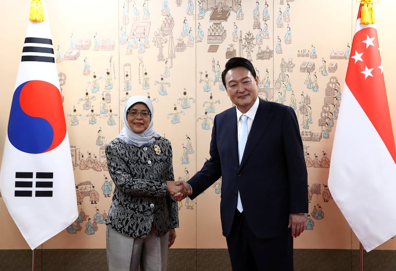 Former Singaporean President Halimah Yacob (left) spoke out against Winters' depiction of workers.