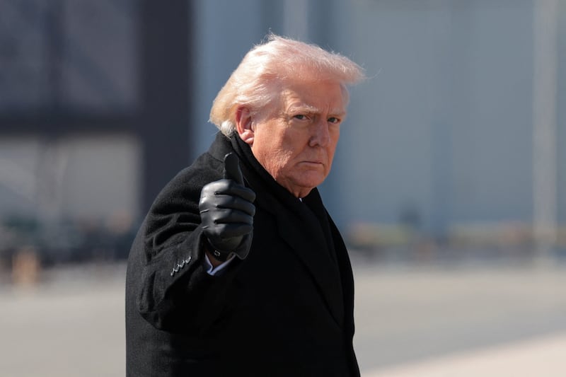U.S. President Donald Trump gestures, as he walks to board Air Force One to travel to Joint Base Andrews, at Dover Air Force Base in Dover, Delaware, U.S., March 18.