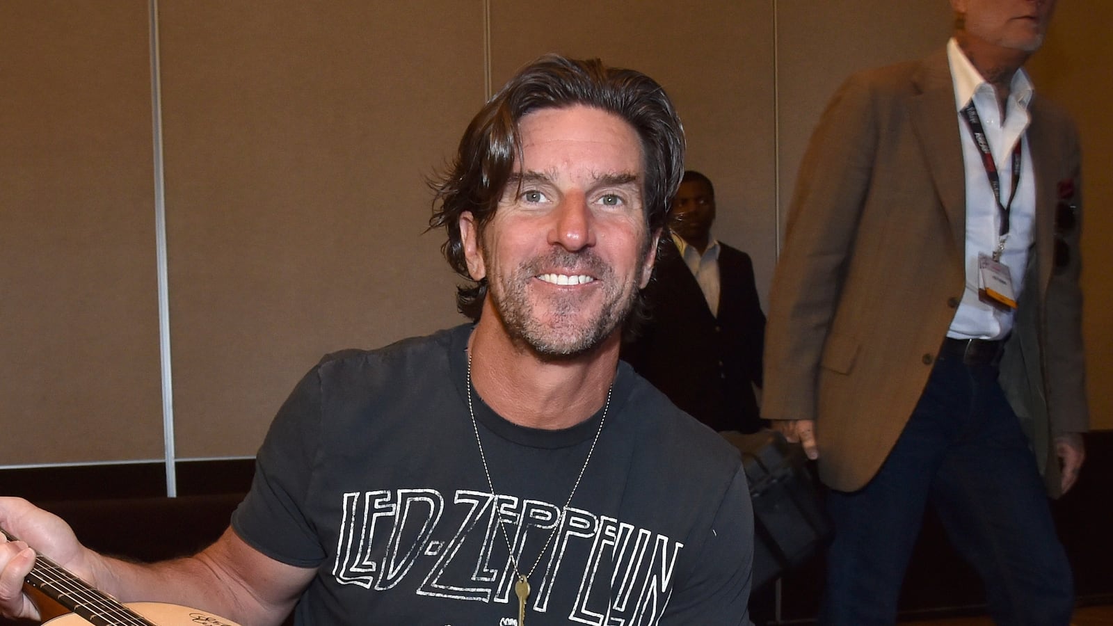 Songwriter Brett James poses with a #StandWithSongwriters guitar