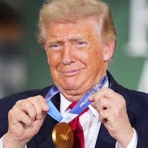 U.S. President Donald Trump holds a gold Olympic medal belonging to U.S. speed skater and Wisconsin native Jordan Stolz during an event at Custer Farms in Chippewa Falls, Wisconsin, U.S., June 5, 2026.