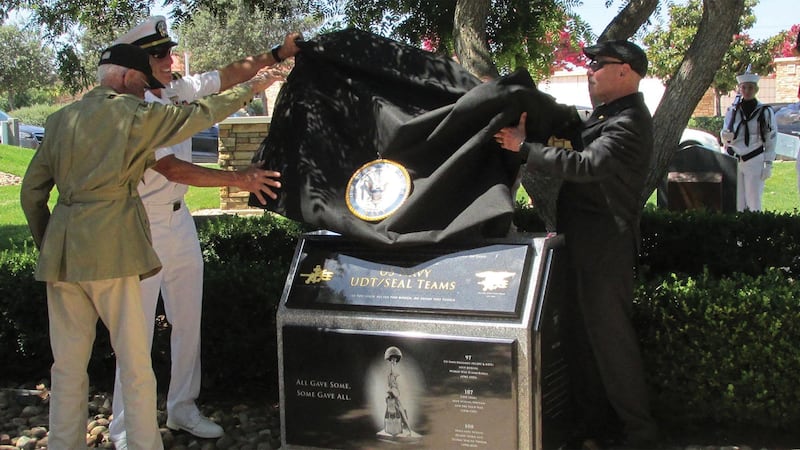 A U.S. Navy UDT/SEAL monument is unveiled during a dedication ceremony at Miramar National Cemetery in San Diego on Aug. 27, 2021